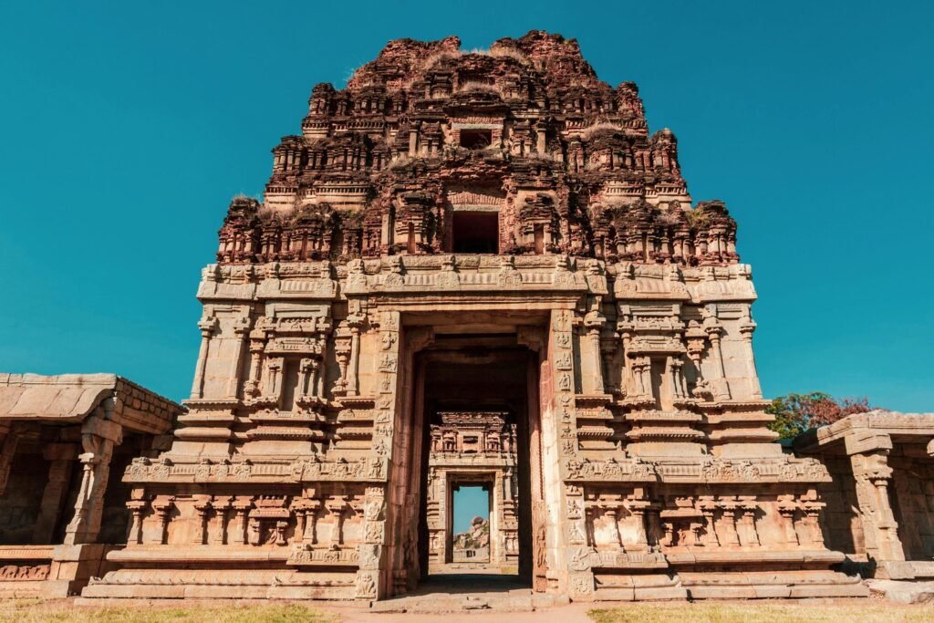 Ancient stone temples of Hampi under a bright blue sky